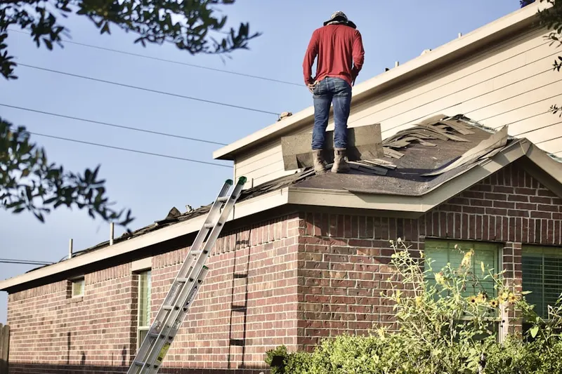 Professional roofer working on a residential roof in Cold Saturday